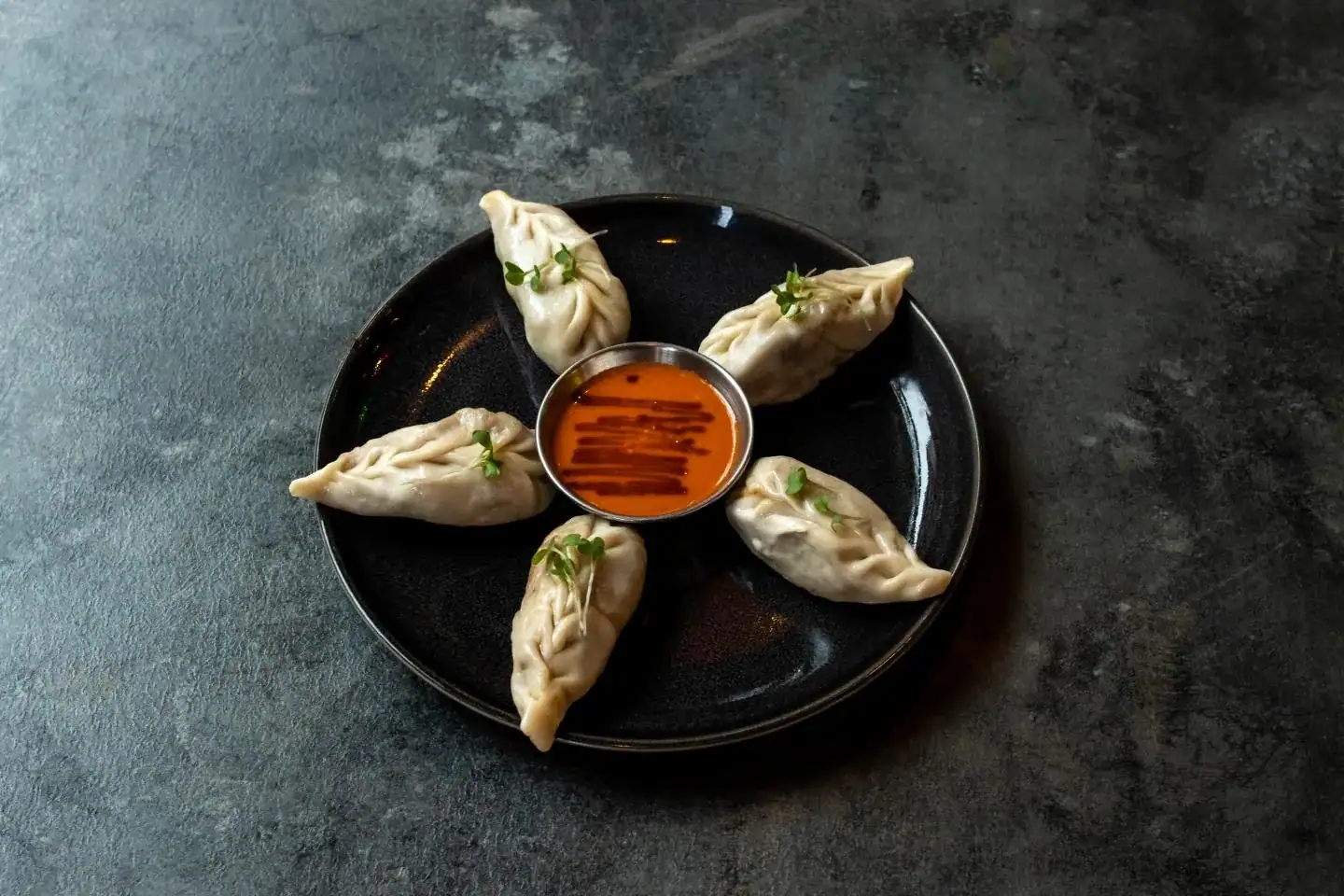 Steamed momo at Nukkad Café, Glasgow: soft steamed dumplings filled with your choice of vegetable or chicken, served with spicy chutney